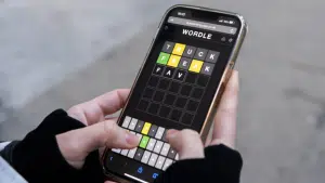 Image showing a man using Wordle Hint today to solve challenge