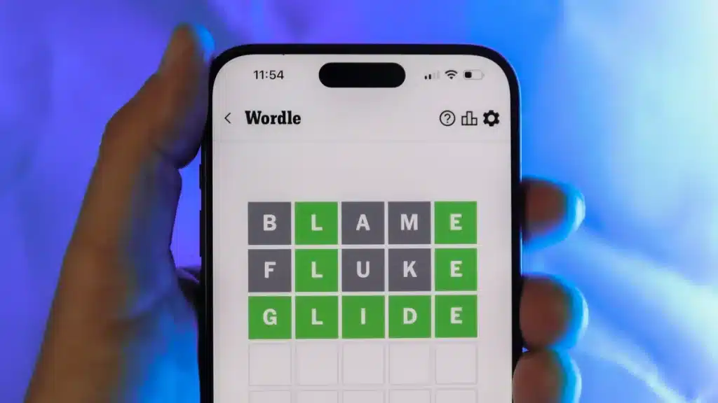 Image showing a mobile phone in a hand of a man playing Wordle